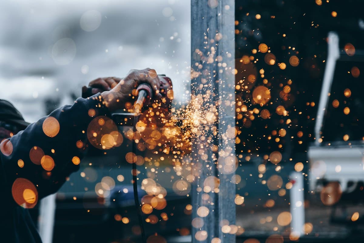 Construction professional performing metal work safely